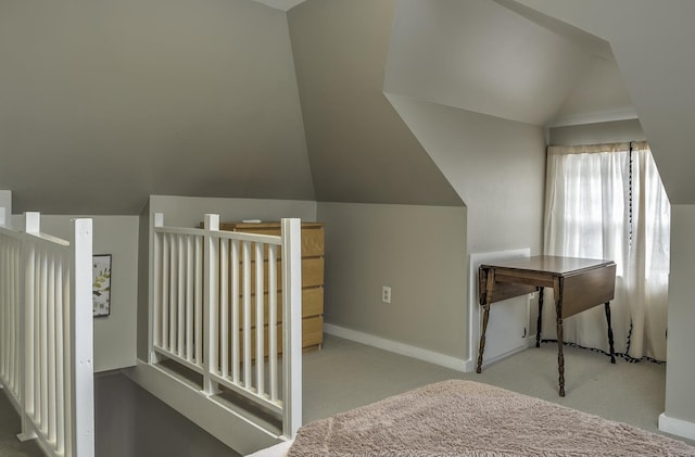 additional living space with light carpet and vaulted ceiling