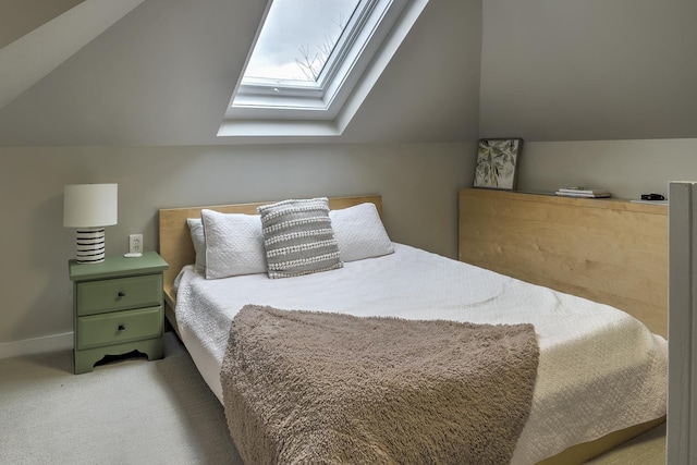 bedroom with light colored carpet and lofted ceiling with skylight