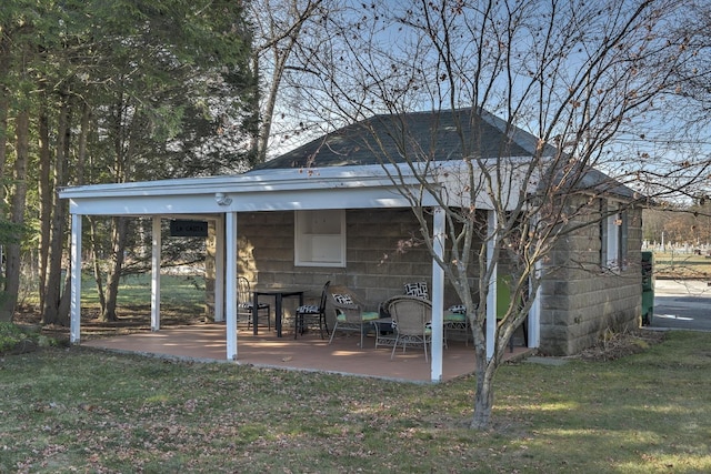 rear view of house featuring a lawn and a patio area