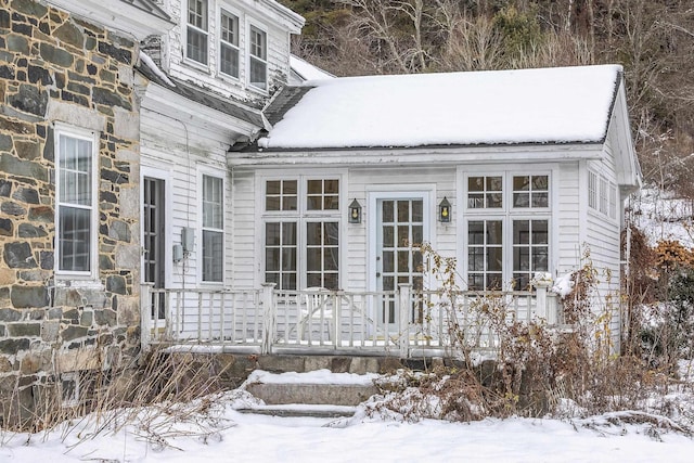 view of snow covered property entrance