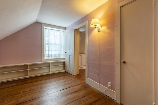 additional living space with lofted ceiling and dark wood-type flooring