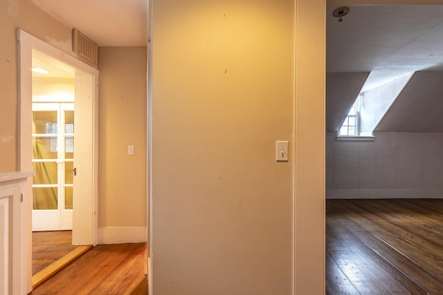 hall with hardwood / wood-style floors