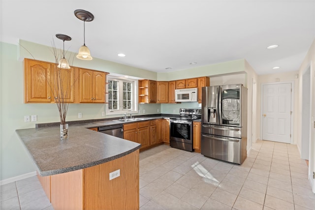 kitchen featuring sink, stainless steel appliances, kitchen peninsula, decorative light fixtures, and light tile patterned floors