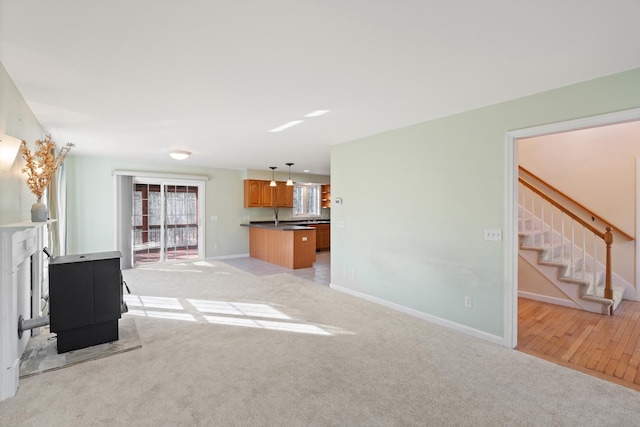 unfurnished living room featuring light carpet