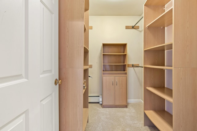 walk in closet featuring a baseboard radiator and light colored carpet