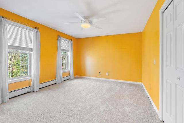 interior space featuring light carpet, multiple windows, and ceiling fan