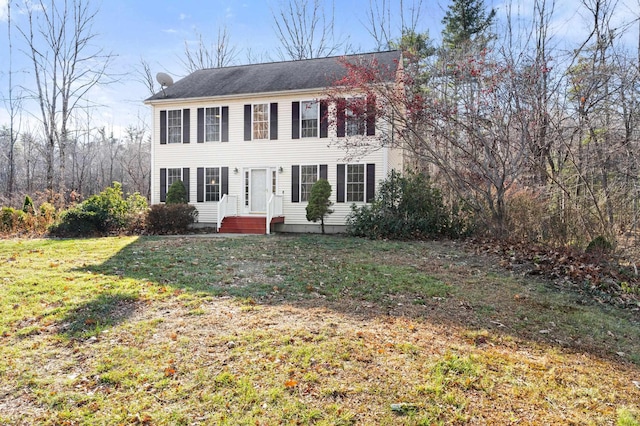 colonial home with a front lawn