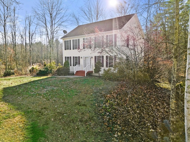 colonial home with a front lawn