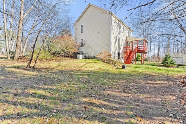 view of home's exterior featuring central AC, a deck, and a lawn