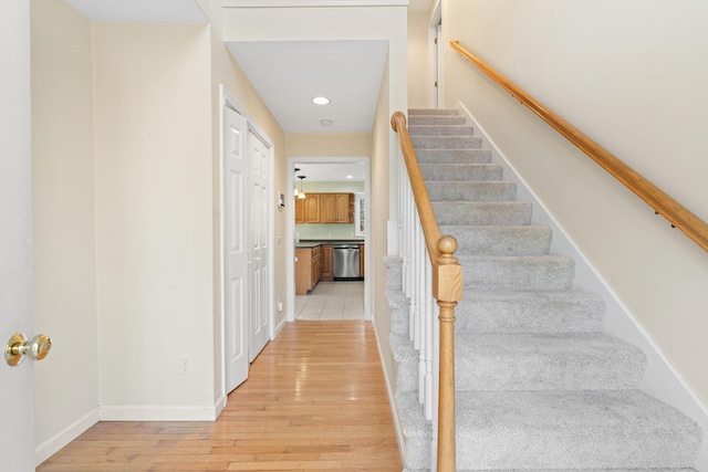 stairway with hardwood / wood-style floors