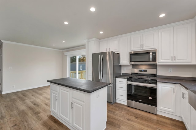 kitchen with white cabinetry, a kitchen island, and appliances with stainless steel finishes