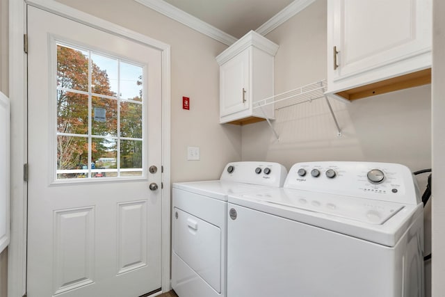 washroom featuring washer and dryer, crown molding, and cabinets