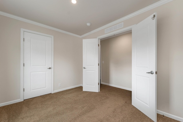 unfurnished bedroom featuring carpet and crown molding