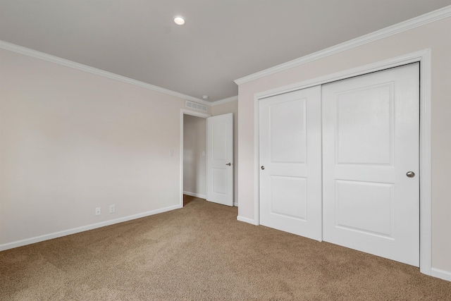 unfurnished bedroom with carpet, a closet, and crown molding