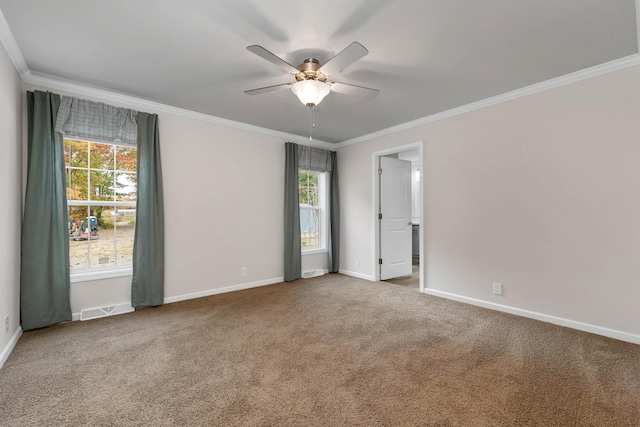 carpeted empty room featuring ceiling fan and crown molding