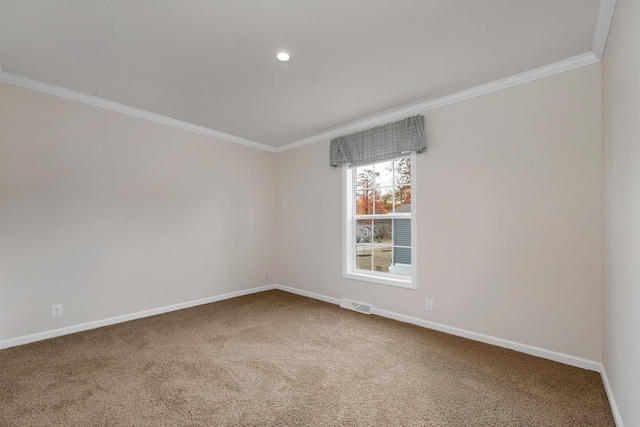 empty room featuring carpet flooring and ornamental molding