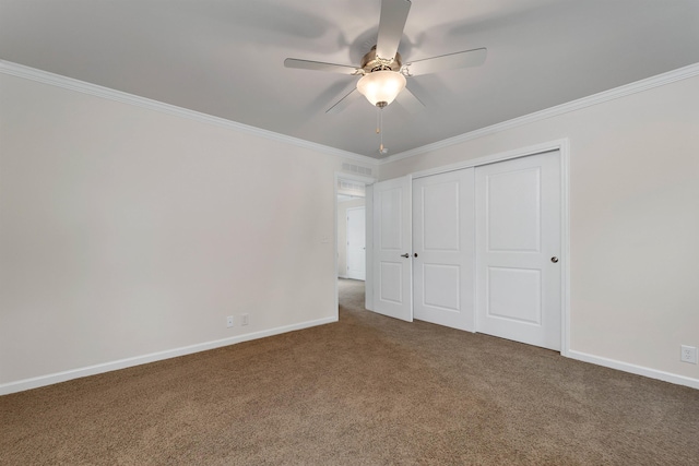 unfurnished bedroom featuring carpet flooring, ceiling fan, a closet, and ornamental molding