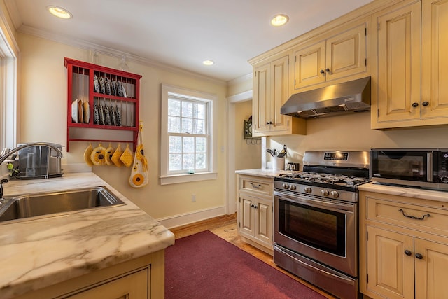 kitchen featuring cream cabinets, crown molding, sink, light hardwood / wood-style flooring, and stainless steel range with gas stovetop