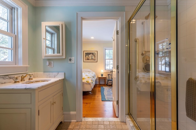 bathroom featuring crown molding, a shower with door, and vanity