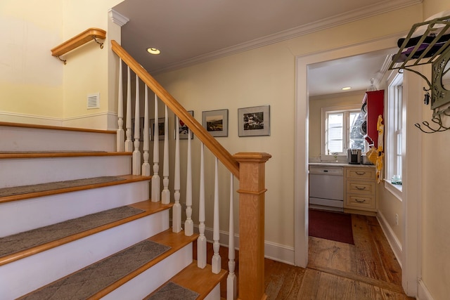 stairway featuring wood-type flooring and ornamental molding