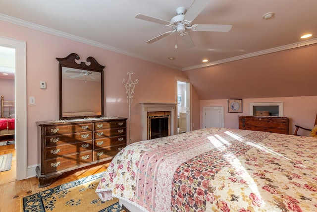 bedroom featuring ceiling fan, hardwood / wood-style flooring, vaulted ceiling, and ornamental molding