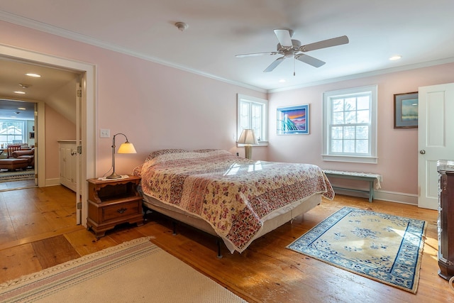 bedroom with hardwood / wood-style floors, ceiling fan, and crown molding