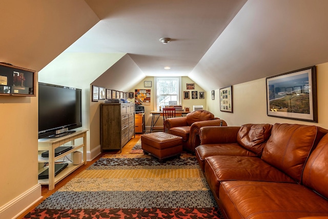 living room with hardwood / wood-style floors and lofted ceiling