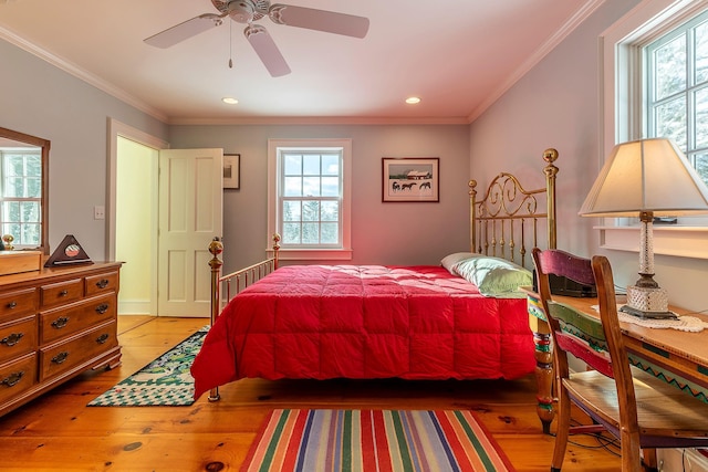 bedroom featuring hardwood / wood-style floors, ceiling fan, and ornamental molding