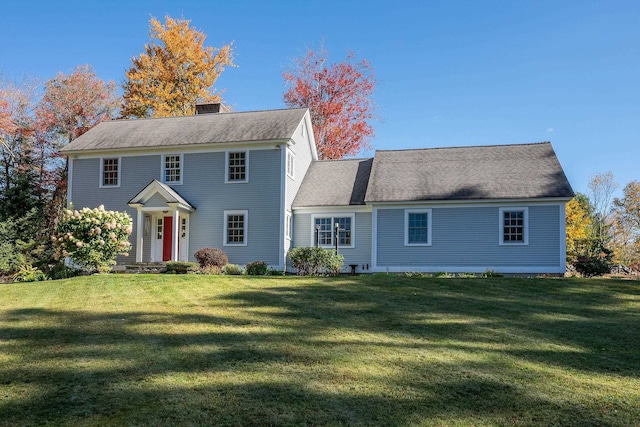 rear view of house with a yard