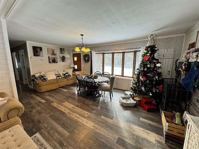 dining area featuring a textured ceiling, dark wood-type flooring, and a notable chandelier