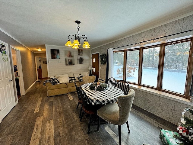 dining space with crown molding, dark hardwood / wood-style flooring, and a notable chandelier