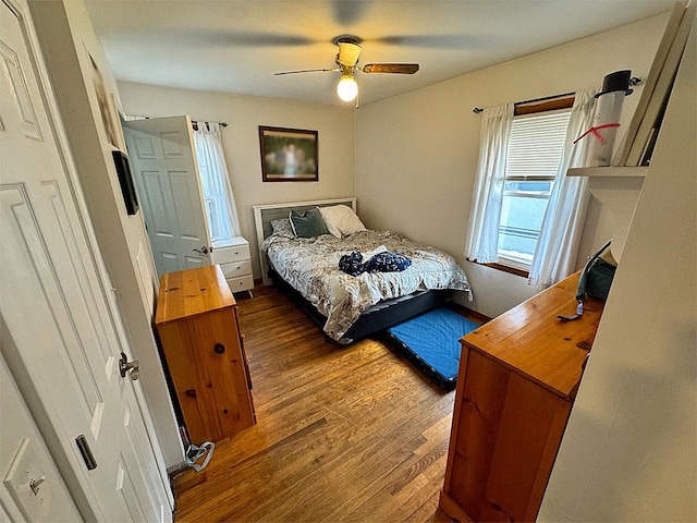 bedroom with ceiling fan and hardwood / wood-style floors