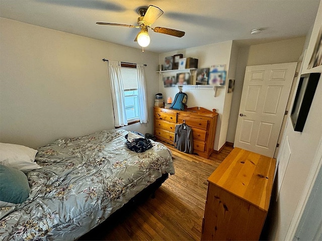 bedroom with ceiling fan and dark wood-type flooring