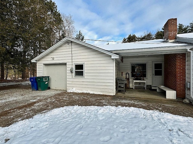 view of snow covered rear of property