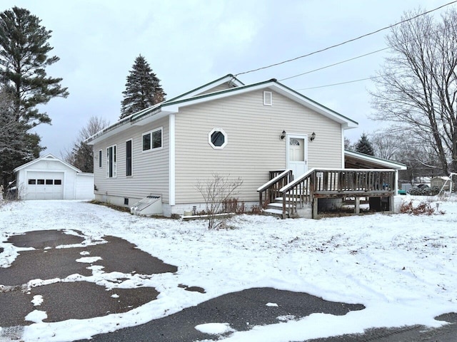 view of front of property featuring a garage and an outdoor structure