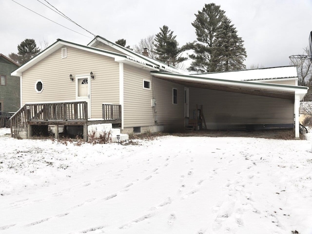 view of snow covered rear of property