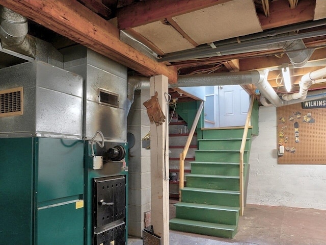 basement with a workshop area and heating unit