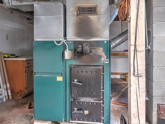 utility room featuring heating unit