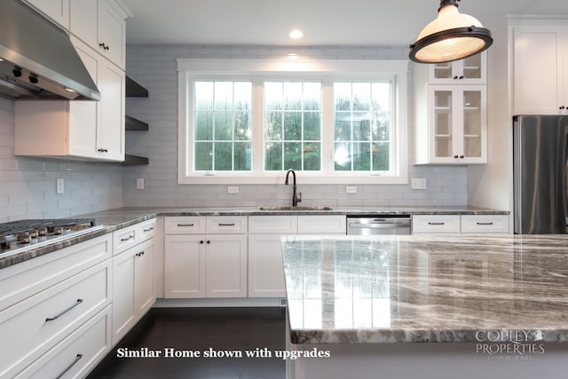 kitchen featuring sink, light stone countertops, range hood, white cabinetry, and stainless steel appliances