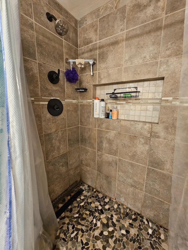 bathroom with a tile shower