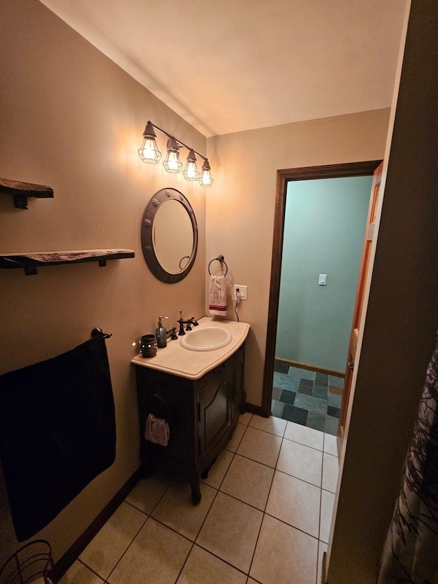 bathroom featuring tile patterned floors, vanity, and baseboards