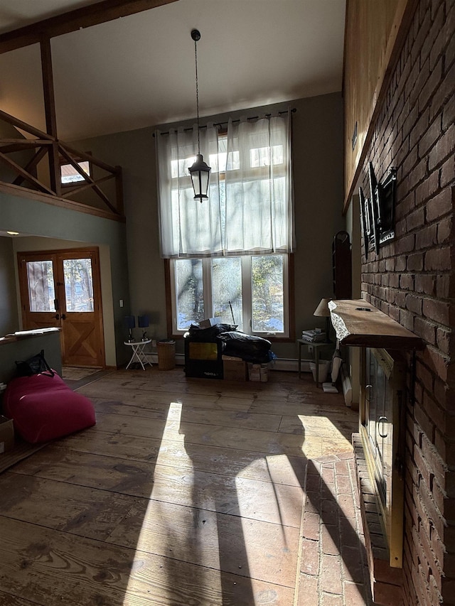 dining area with a towering ceiling and hardwood / wood-style flooring