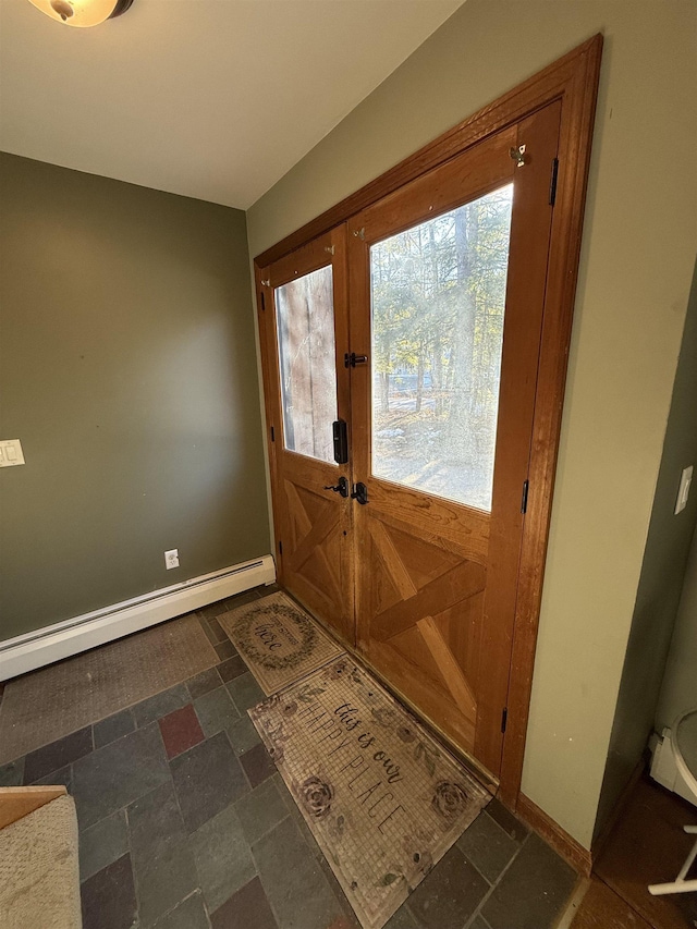 entryway with a baseboard radiator, baseboards, stone tile flooring, and french doors