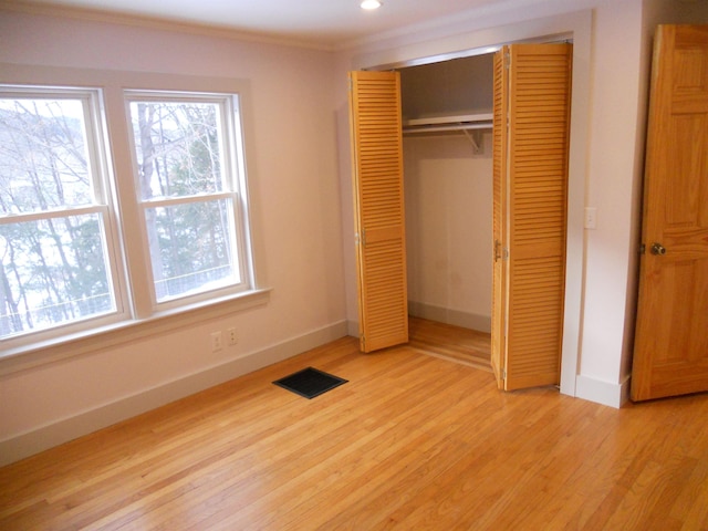 unfurnished bedroom with light hardwood / wood-style floors and a closet