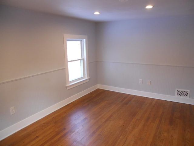 spare room with dark hardwood / wood-style flooring