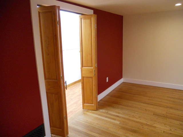 corridor with light wood-type flooring