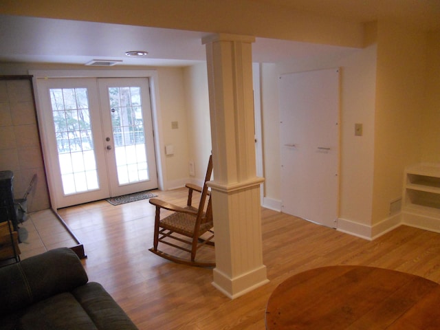 entryway featuring french doors, light hardwood / wood-style flooring, and ornate columns