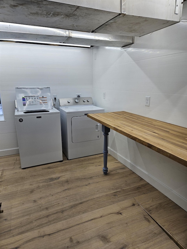 laundry room featuring independent washer and dryer and hardwood / wood-style floors