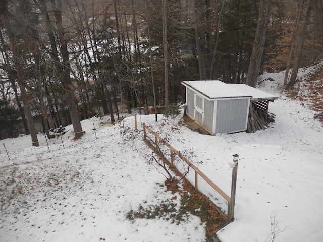 yard covered in snow featuring an outdoor structure