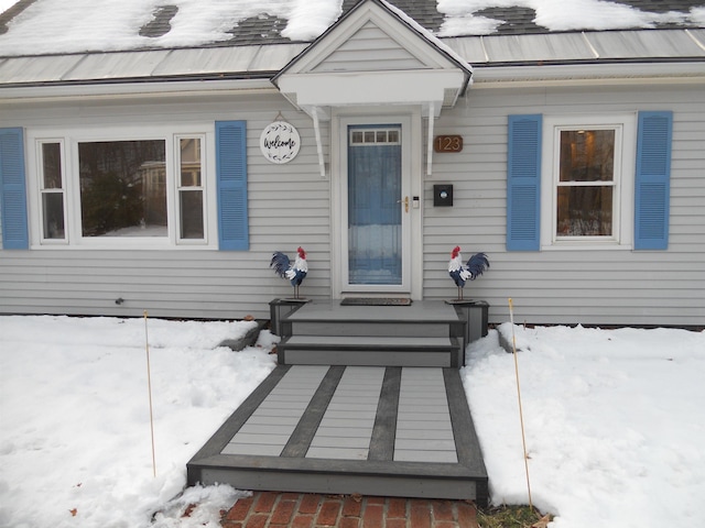 view of snow covered property entrance